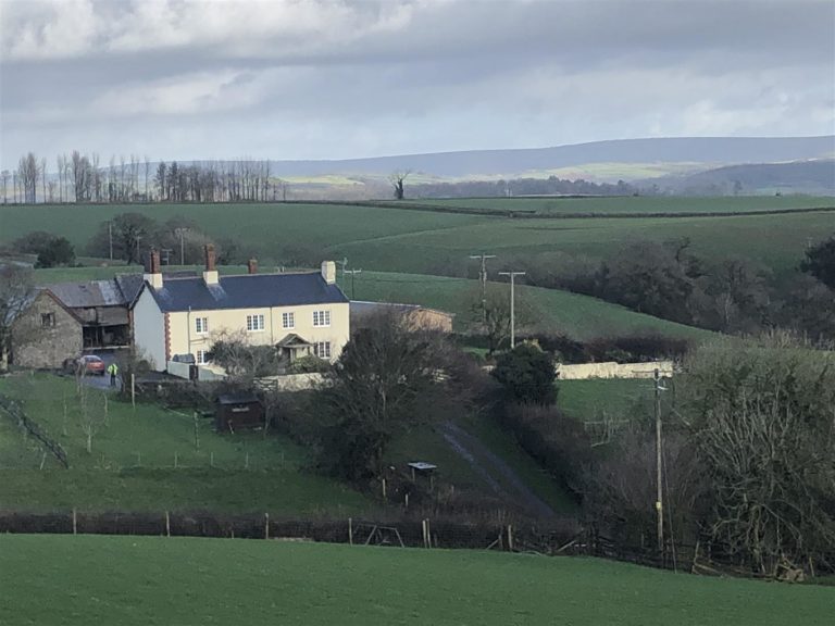 A south facing farmhouse with two cottages 40 acres and a large agricultural building nr South